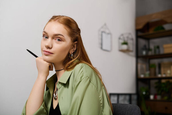 Young woman relaxes in a cozy home environment, pondering with a pen in hand.