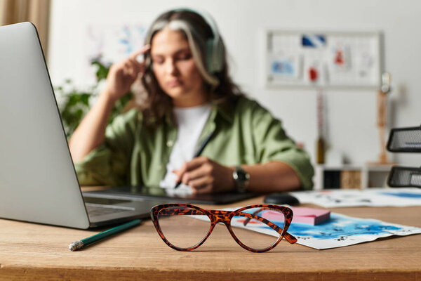 A woman with a white forelock works on an art project at her stylish home desk.