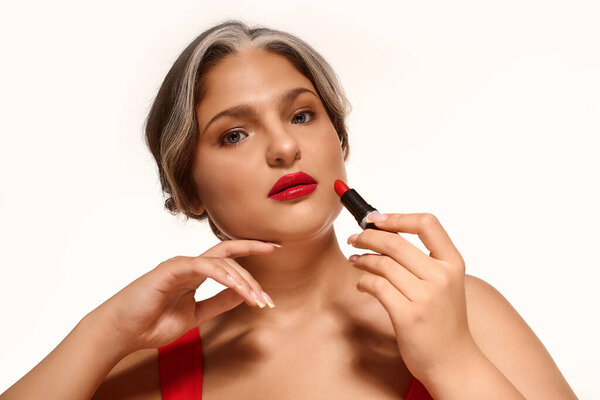 A young woman highlights her red lips and distinctive white forelock, celebrating diversity.