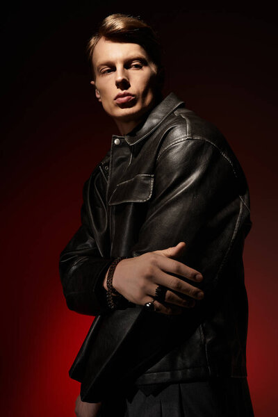 A handsome young man poses confidently, showcasing modern masculinity against a vivid backdrop.