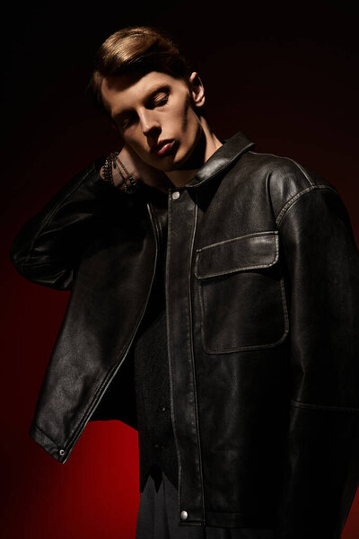 A young man showcases his allure in dark leather wear, embodying contemporary masculinity.