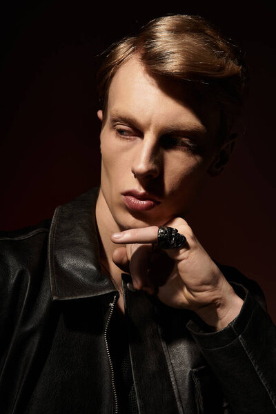 A young man with striking features showcases modern masculinity, exuding confidence and style.