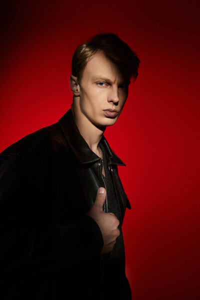 A handsome young man showcases modern masculinity with a powerful stance and confident expression.