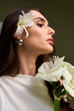 Sakin bir sahnede, genç bir gelin saçlarında çiçekler ve bir buketle zarafet saçar..