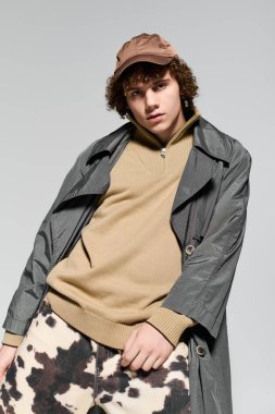 Genç, modaya uygun bir şekilde poz veriyor, günlük tarzla canlı kişiliği harmanlıyor..