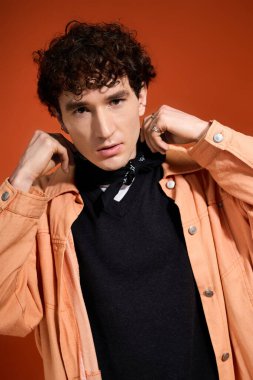 Çekici bir birey kıyafetini ayarlar, kendine güveni ve modern yetenekleri yayar..