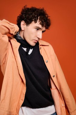 Handsome man showcases elegant attire, blending casual and trendy elements in a striking setting.