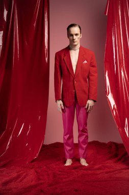 Kendine güvenen bir adam canlı bir ortamda durur, Sevgililer Günü 'nde moda yoluyla gururunu gösterir..