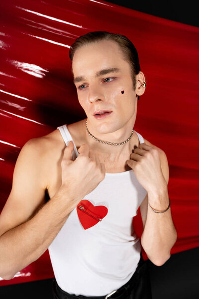 A man showcases his unique style and confidence on Valentine Day, embracing queer culture.