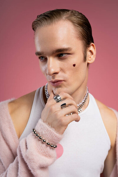 A young man embraces Valentine Day, showcasing his unique style and pride in a colorful setting.