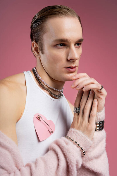 A stylish man expresses his love uniquely this Valentine Day in a soft pink setting.