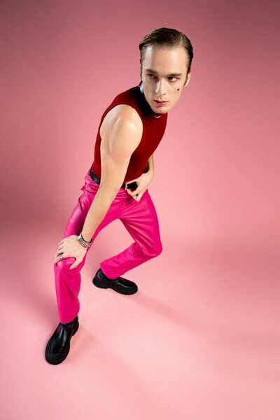 A man showcases bold style and confidence, celebrating Valentine Day with bright colors.