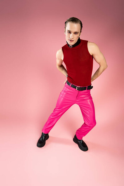 A cheerful man showcases his colorful outfit, exuding confidence and pride on Valentines Day.