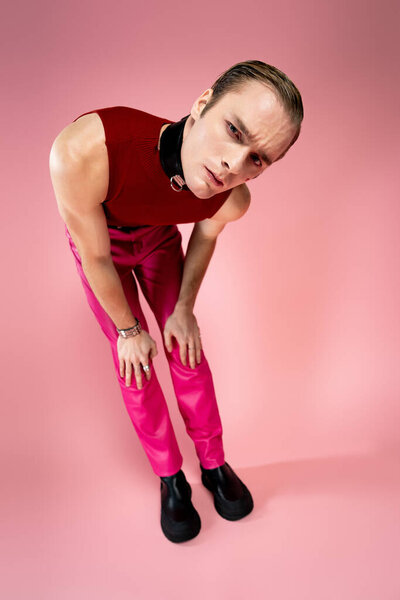 A man stands confidently in red and pink, showcasing his unique style for Valentines Day.