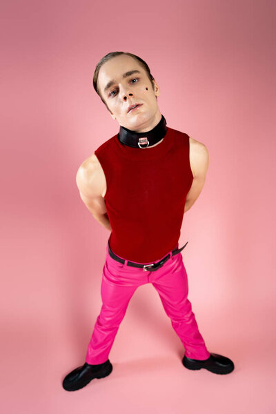 A man showcases his individuality with bold fashion choices on Valentine Day, surrounded by love.