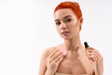 Güzel, genç bir kadın şık bir stüdyoda kendine güveni ile makyaj yeteneklerini sergiliyor..