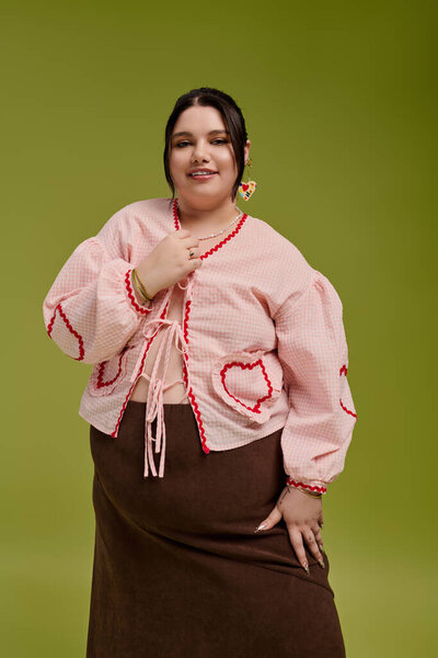 A beautiful plus size woman poses confidently in a chic outfit, emphasizing her unique style.