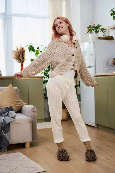 Parlak ve neşeli bir kadın şık, rahat bir ev ortamında, dekorla eğleniyor..