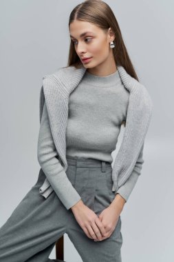 Şık bir genç kadın minimalist bir ortamda zarafet ve sükunet yayar..