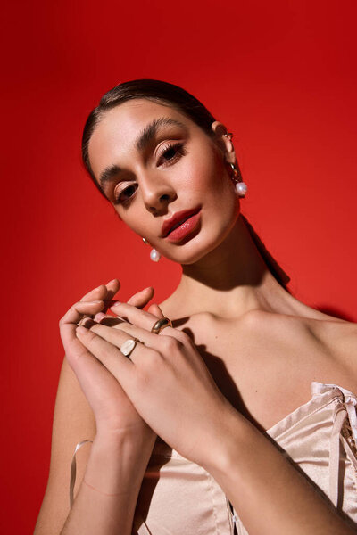 Graceful young woman showcases her beauty with a confident expression in a vivid setting