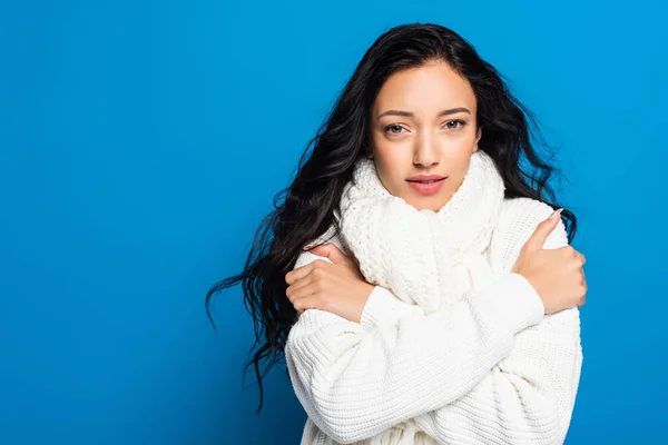 Brunette young woman in knitted scarf freezing isolated on white — Stock Photo