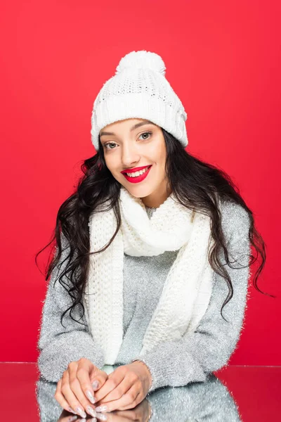 Joyful woman in hat and warm scarf isolated on red — Stock Photo