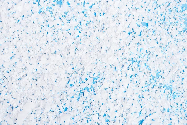 Top view of artificial snow on blue background, new year concept — Stock Photo