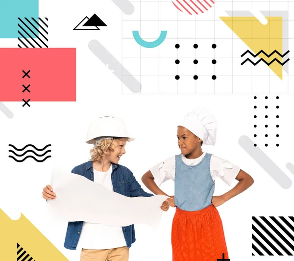 Boy in costume of architect holding blueprint and looking at displeased african american kid standing with hands on hips near illustration on white — Stock Photo