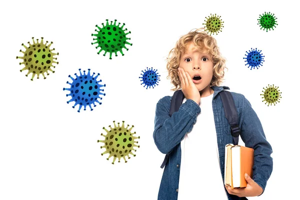 Shocked blonde schoolkid touching face and holding books near viruses illustration on white — Stock Photo