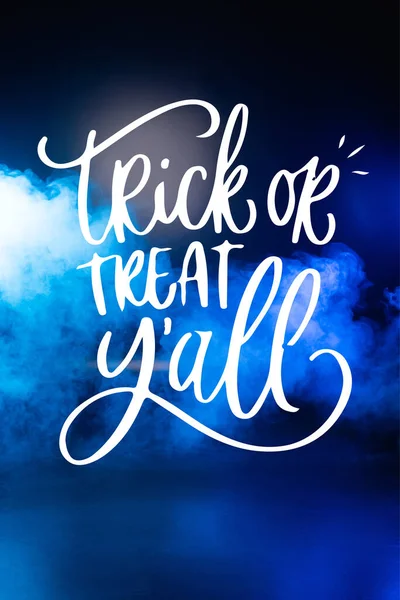 Trick or treat yall lettering on dark blue background with smoke — Stock Photo