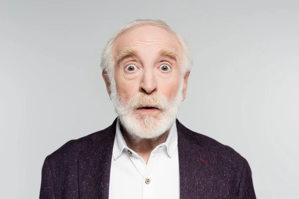 Excited senior man looking at camera isolated on grey — Stock Photo