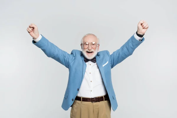 Cheerful senior man showing yeah gesture isolated on grey — Stock Photo