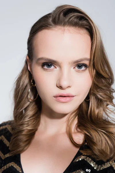 Close up of serious young woman looking at camera isolated on grey — Stock Photo