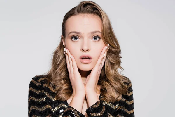 Surprised young woman looking at camera isolated on grey — Stock Photo