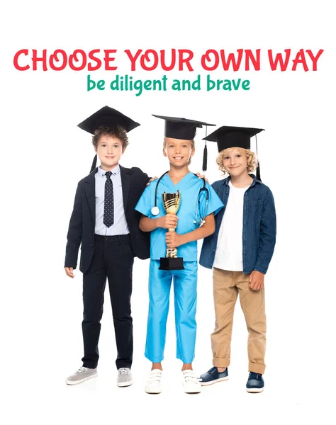 Kids in graduation caps dressed in costumes of different professions holding golden trophy near choose your own way be diligent and brave lettering on white — Stock Photo