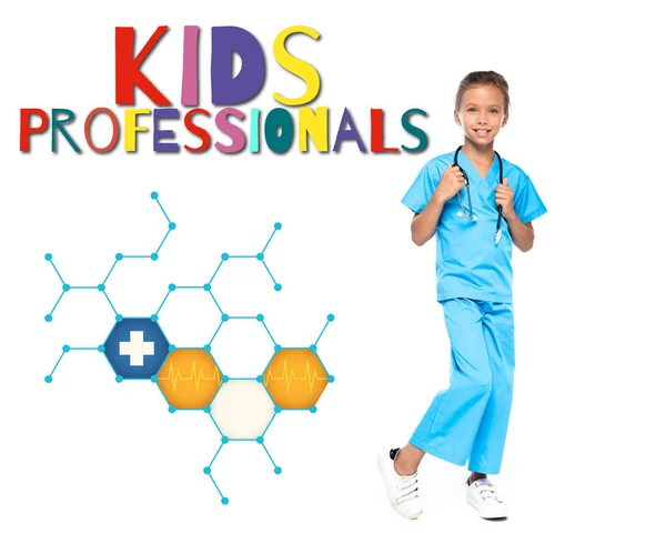 Child in costume of doctor touching stethoscope near kids professionals lettering on white — Stock Photo