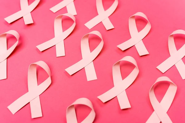 Rows of ribbons of breast cancer awareness on pink background — Stock Photo