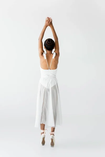 Back view of graceful african american ballerina dancing isolated on white — Stock Photo