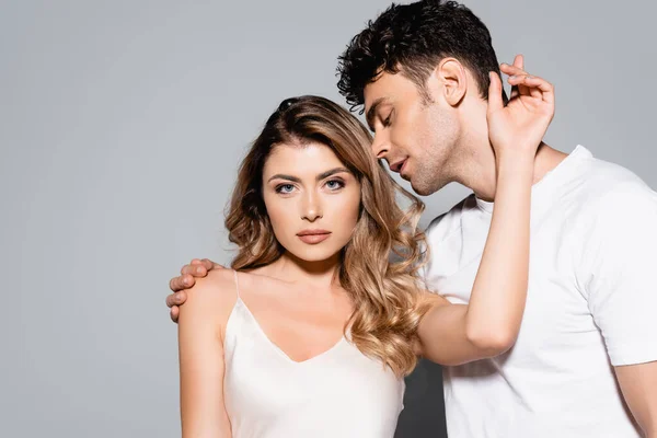 Young beautiful couple posing isolated on grey — Stock Photo