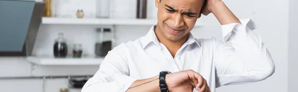 Stressed african american man looking at watch, banner — Stock Photo