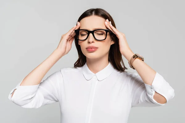 Young businesswoman suffering from headache isolated on grey — Stock Photo