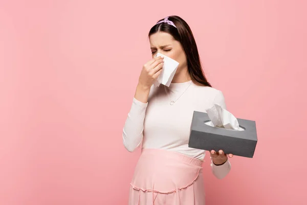 Young pretty pregnant woman with runny nose isolated on pink — Stock Photo