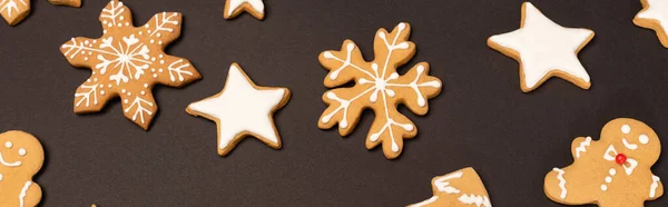 Top view of gingerbread cookies on black background, banner — Stock Photo