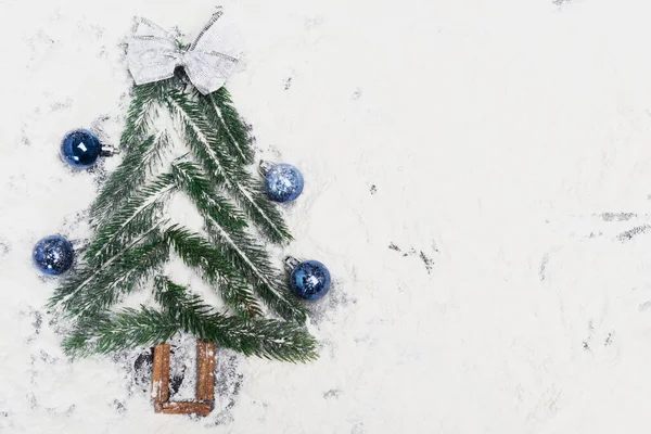 Top view of decorated Christmas tree on snow — Stock Photo