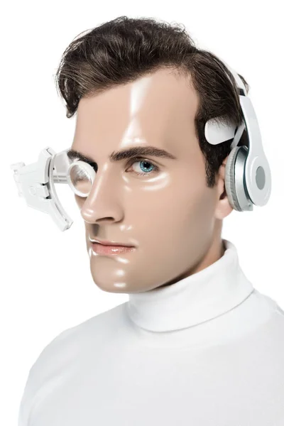 Morena cyborg en auriculares y lente de ojo mirando a la cámara aislada en blanco - foto de stock