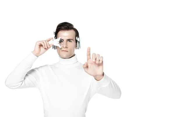 Cyborg in headphones and digital eye lens touching something isolated on white — Stock Photo