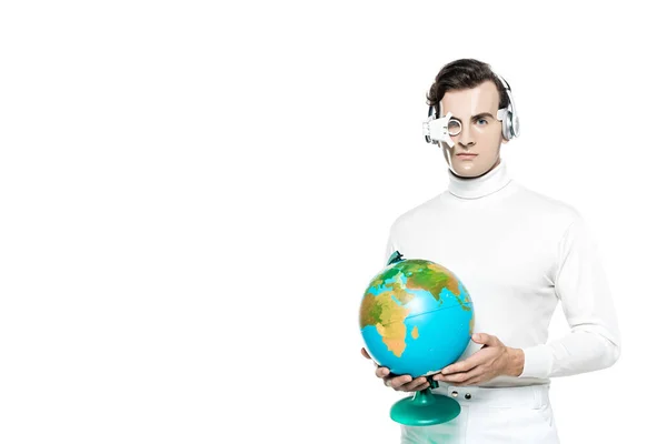 Cyborg man in digital eye lens and headphones holding globe isolated on white — Stock Photo