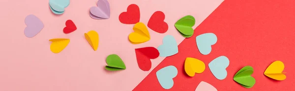 Top view of colorful paper hearts on red and pink background, banner — Stock Photo
