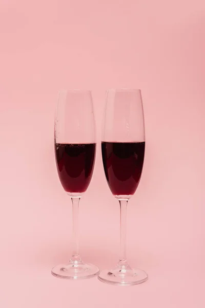 Rotwein in Gläsern isoliert auf rosa — Stockfoto