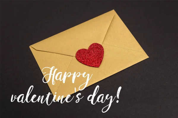 Envelope with heart near happy valentines day lettering on black — Stock Photo